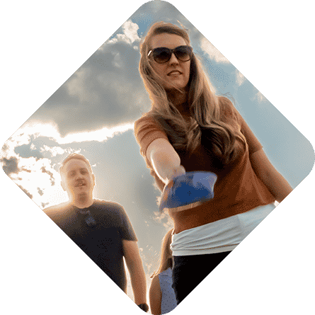 a woman wearing sunglasses and a man in a blue shirt